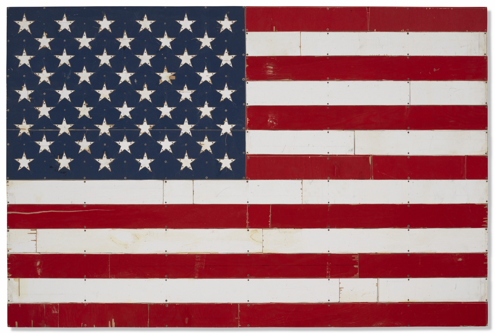 An American flag made of painted plywood strips in red, white and blue, screwed together