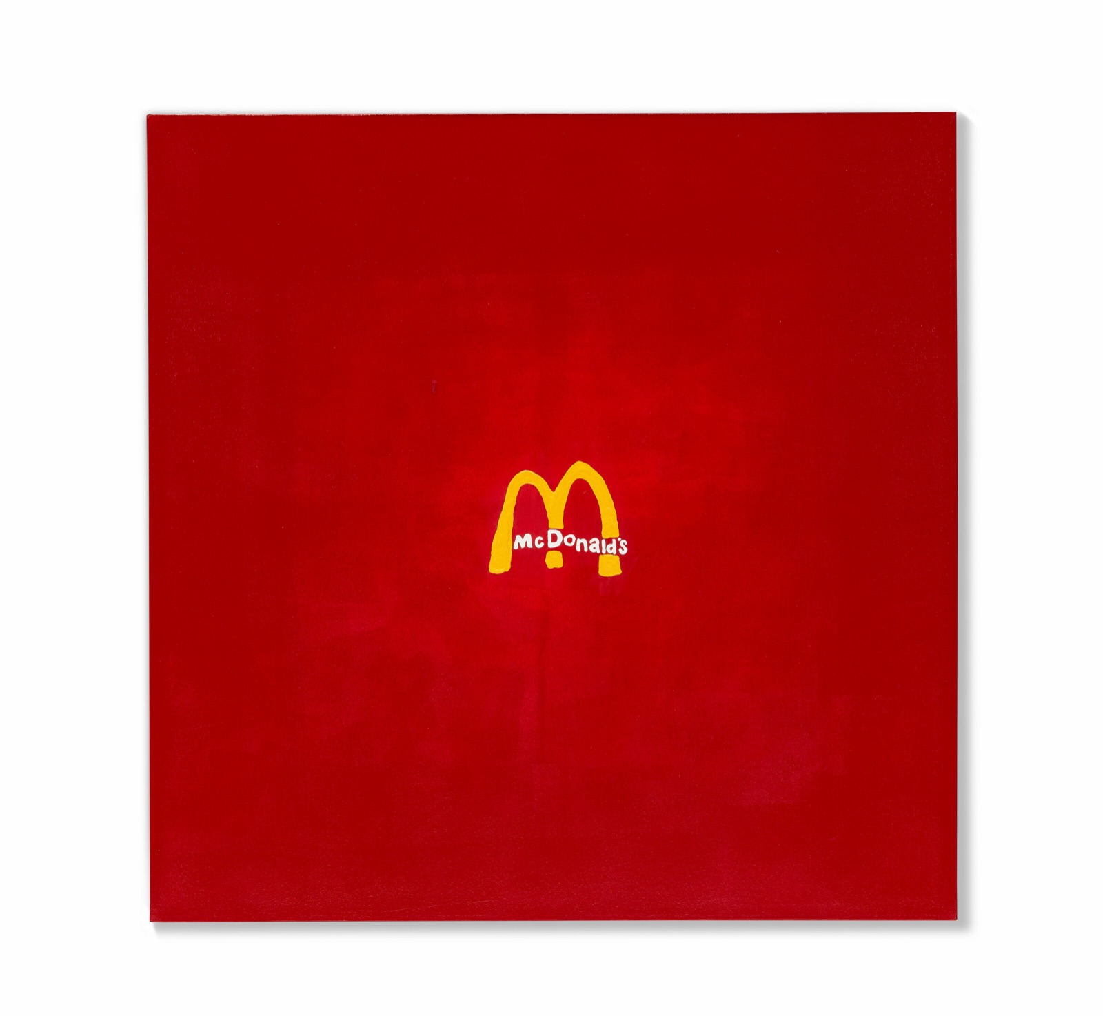 A square red canvas with a small yellow McDonald's arches logo painted at its center